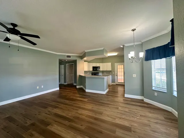 a view of kitchen with refrigerator and window