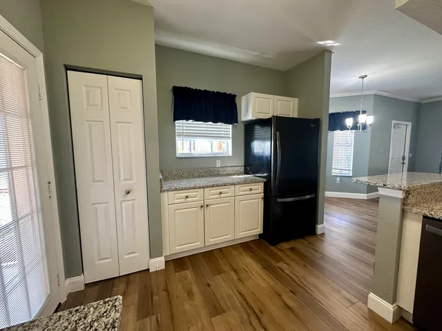 a kitchen with a refrigerator and a sink