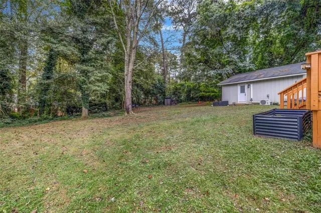 a wooden bench sitting in the middle of a yard