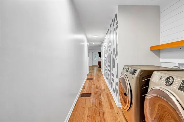 an empty room with ceiling fan and window
