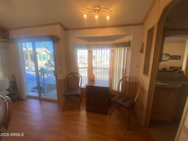 a view of a livingroom with furniture wooden floor and staircase