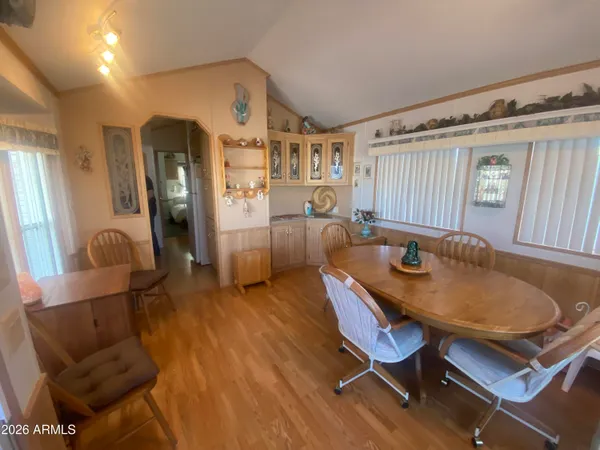 a dining room with furniture and wooden floor