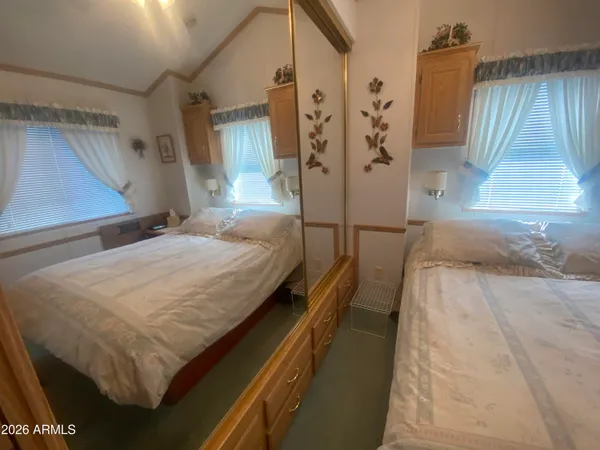 a bedroom with a bed and a large window