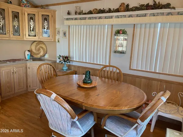 a view of a dining room with furniture and wooden floor