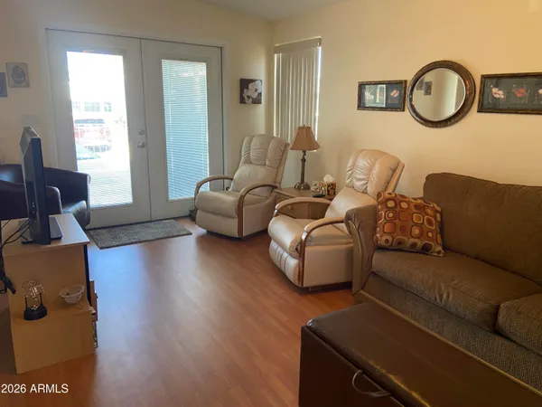 a living room with couches chairs and a large window