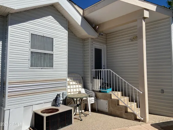 a balcony with table and chairs