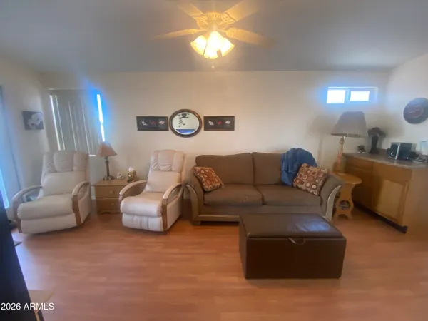 a living room with furniture a lamp and a large window