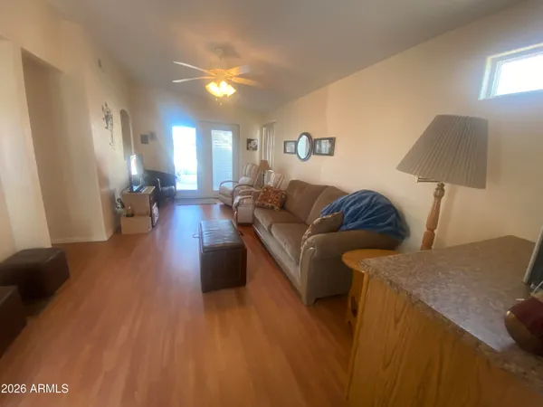 a living room with furniture and a wooden floor