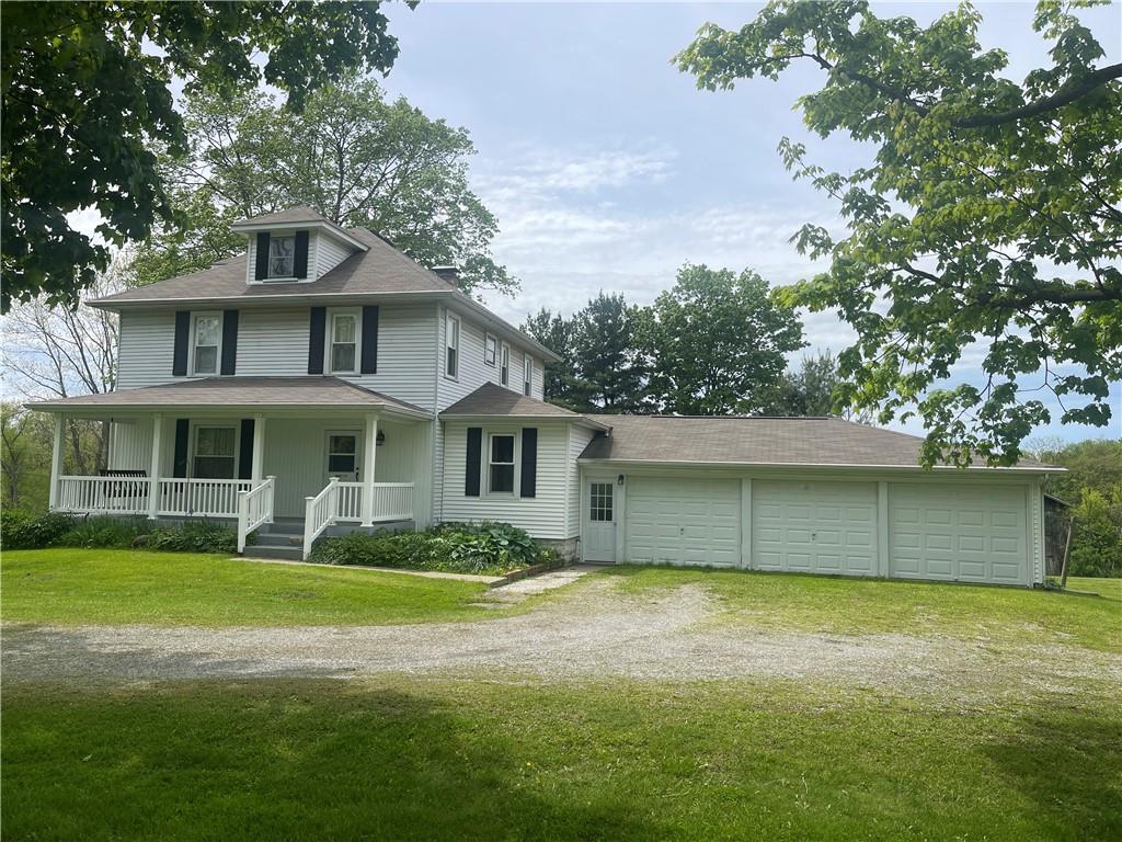 1055 East Lake Road Transfer, PA 16154 - Photo 2 of 27 a front view of a house with a garden
