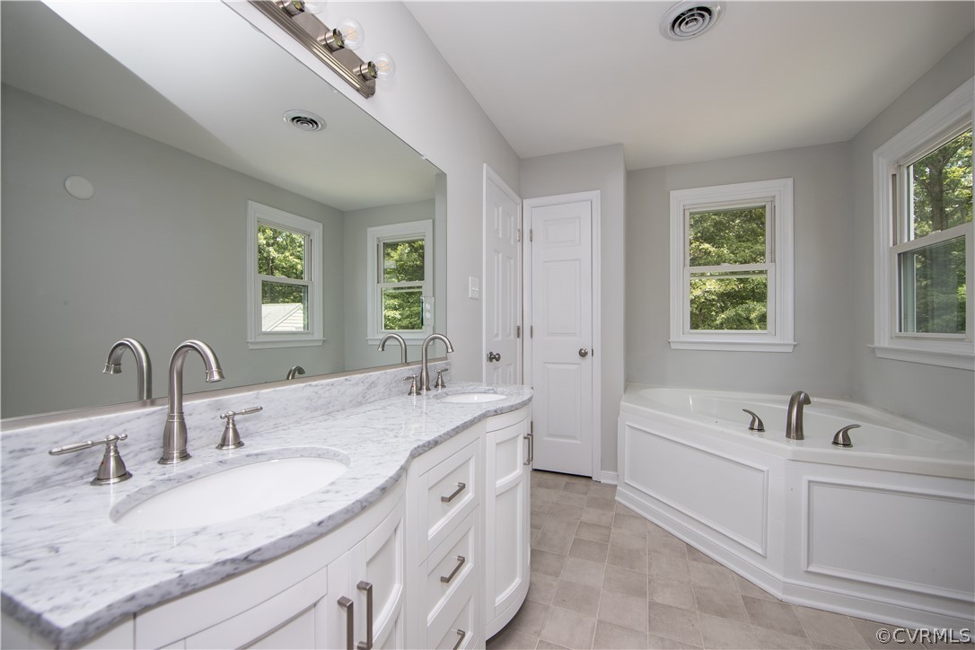 2160 Genito Road Moseley, VA 23120 - Photo 27 of 49 a bathroom with a granite countertop double vanity sink a mirror and a bathtub