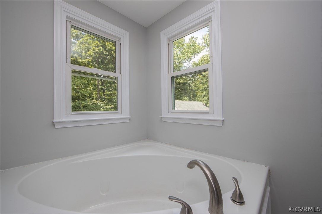 2160 Genito Road Moseley, VA 23120 - Photo 28 of 49 a bath tub sitting in a bathroom next to a window