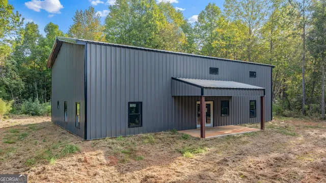 a view of a house with a yard and tree