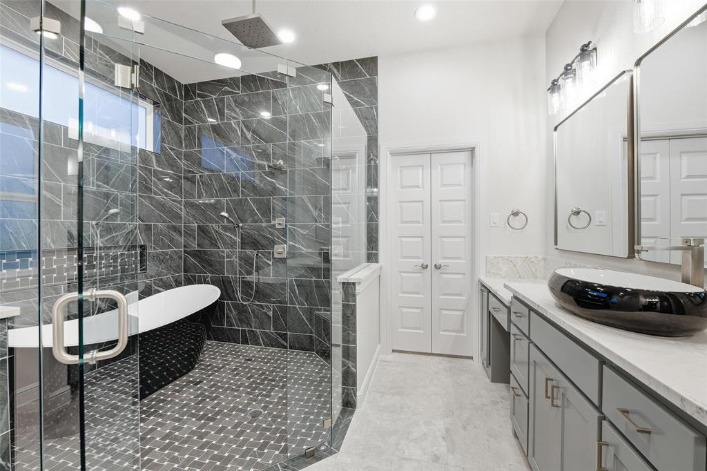 189 Rio Rancho Drive Decatur, TX 76234 - Photo 19 of 36 Bathroom with vanity, a shower stall, a soaking tub, and light tile patterned floors