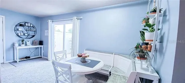 a view of dining room filled with furniture and chandelier