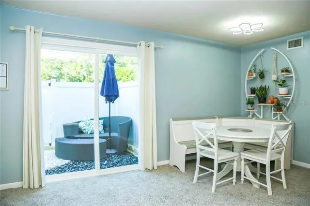 a dining room with furniture and window