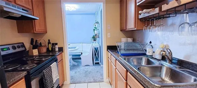 a kitchen that has a sink and a stove