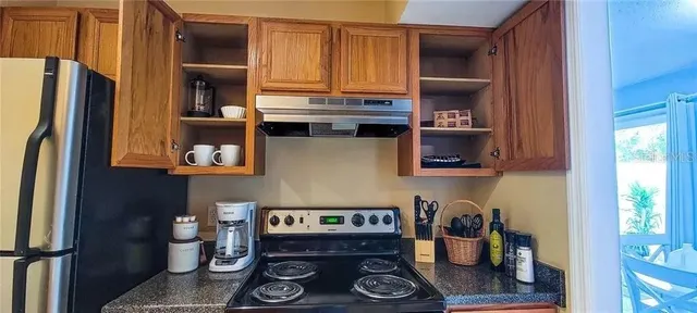 a kitchen with a refrigerator and a stove