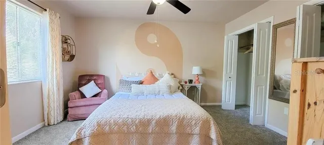 a bed room with a bed and a chandelier