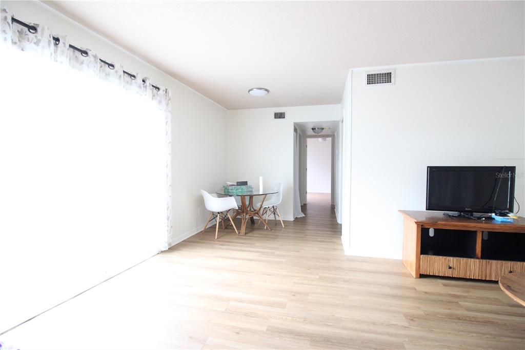 507 Northwest 39th Road, Unit 112 Gainesville, FL 32607 - Photo 18 of 23 a living room with furniture and a flat screen tv