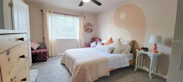 a bedroom with a bed and a chandelier