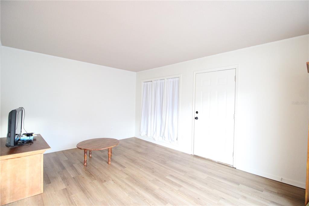 507 Northwest 39th Road, Unit 112 Gainesville, FL 32607 - Photo 4 of 23 a view of a bedroom with wooden floor and bedroom