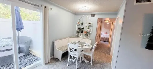 a dining room with furniture and a window