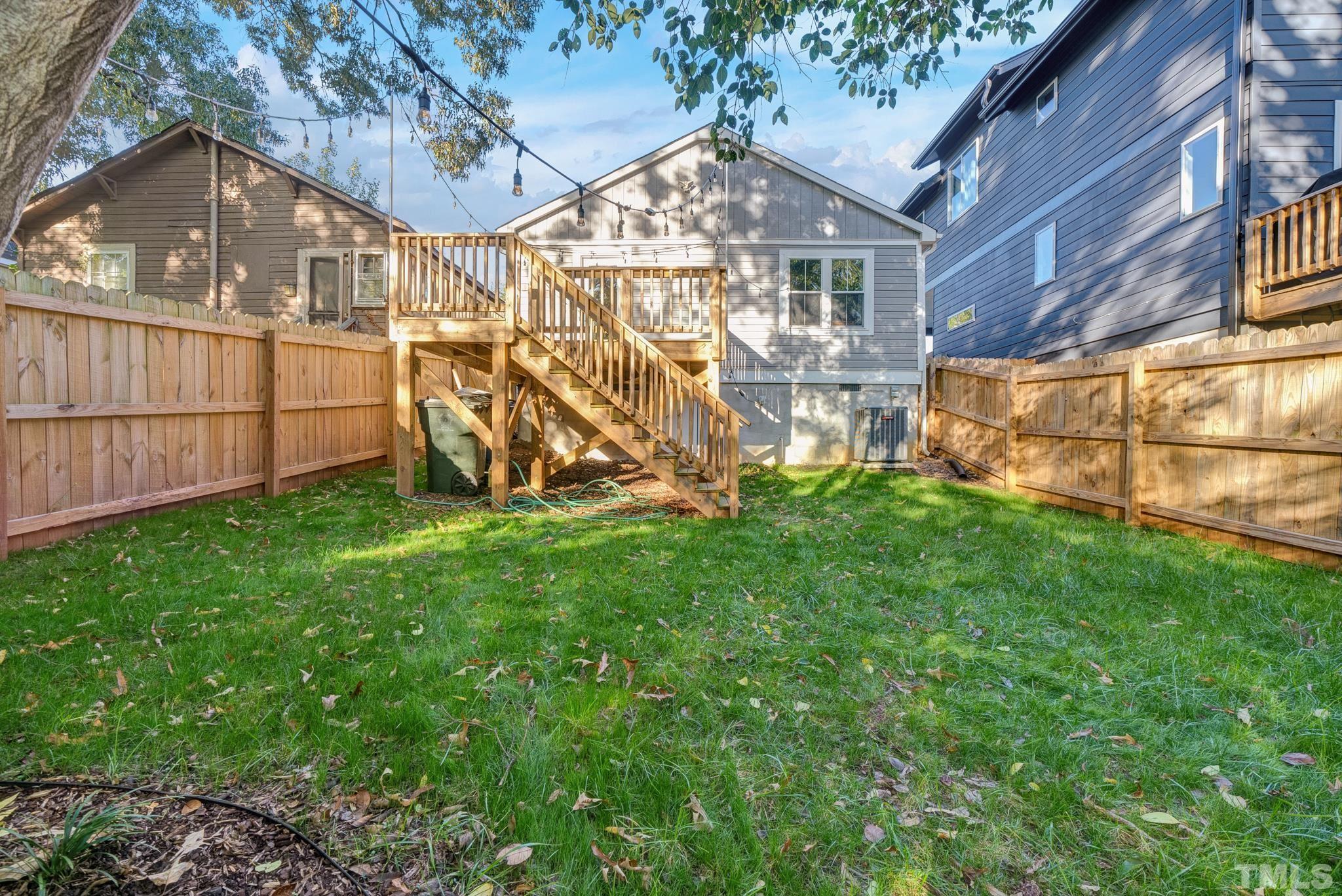 107 Bart Street Raleigh, NC 27610 - Photo 20 of 20 a view of a backyard with a small cabin and wooden fence
