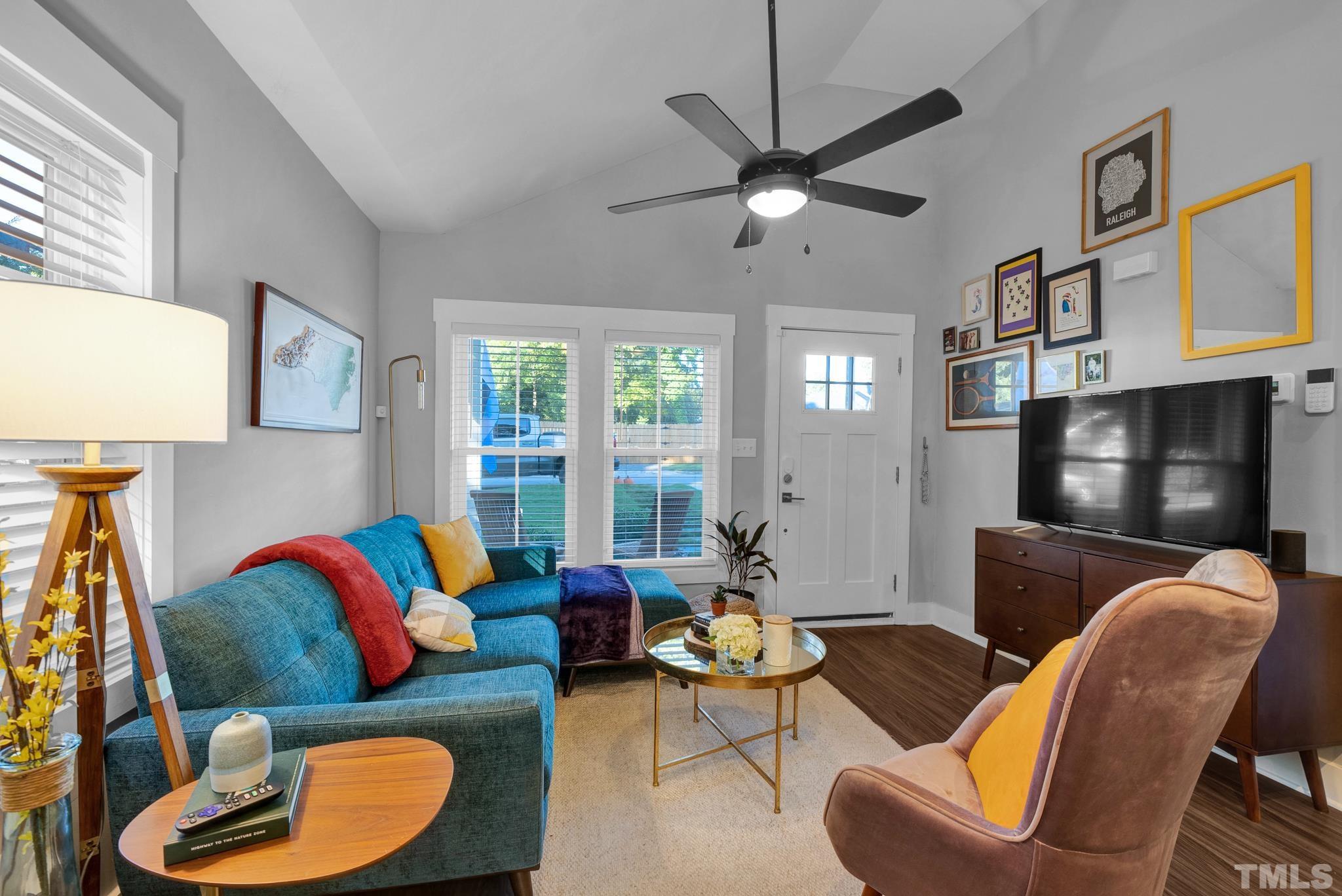 107 Bart Street Raleigh, NC 27610 - Photo 3 of 20 a living room with furniture a ceiling fan and a flat screen tv