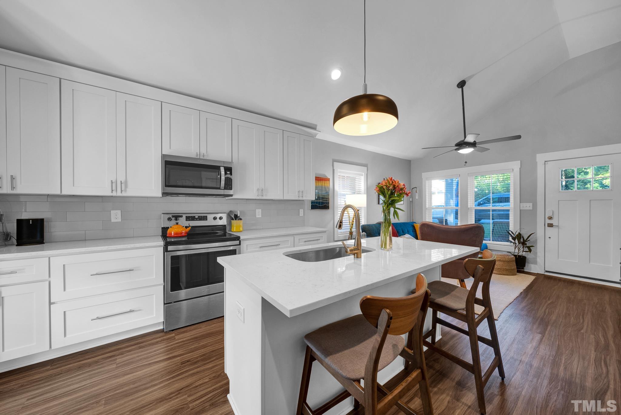 107 Bart Street Raleigh, NC 27610 - Photo 6 of 20 a kitchen with a table chairs microwave and cabinets
