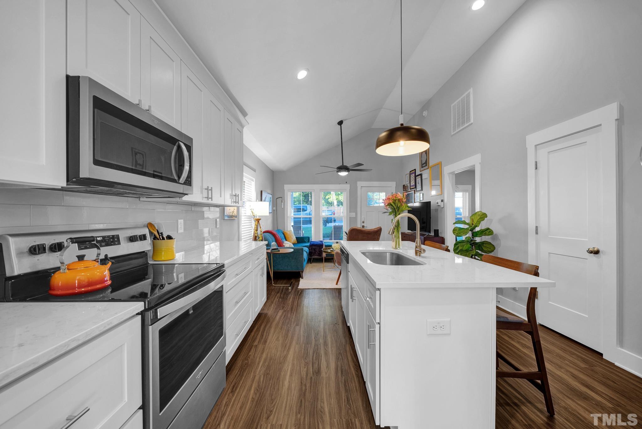 107 Bart Street Raleigh, NC 27610 - Photo 8 of 20 a kitchen with a sink stove and refrigerator