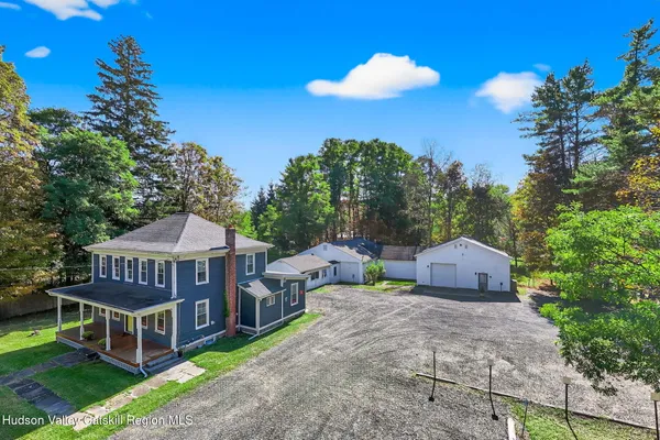 a view of a house with a yard and sitting area