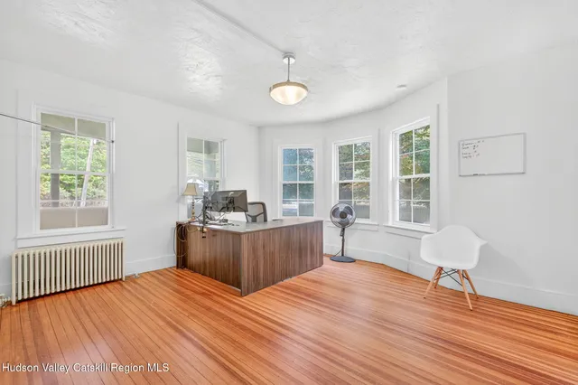 a room with a bed cabinets and wooden floor