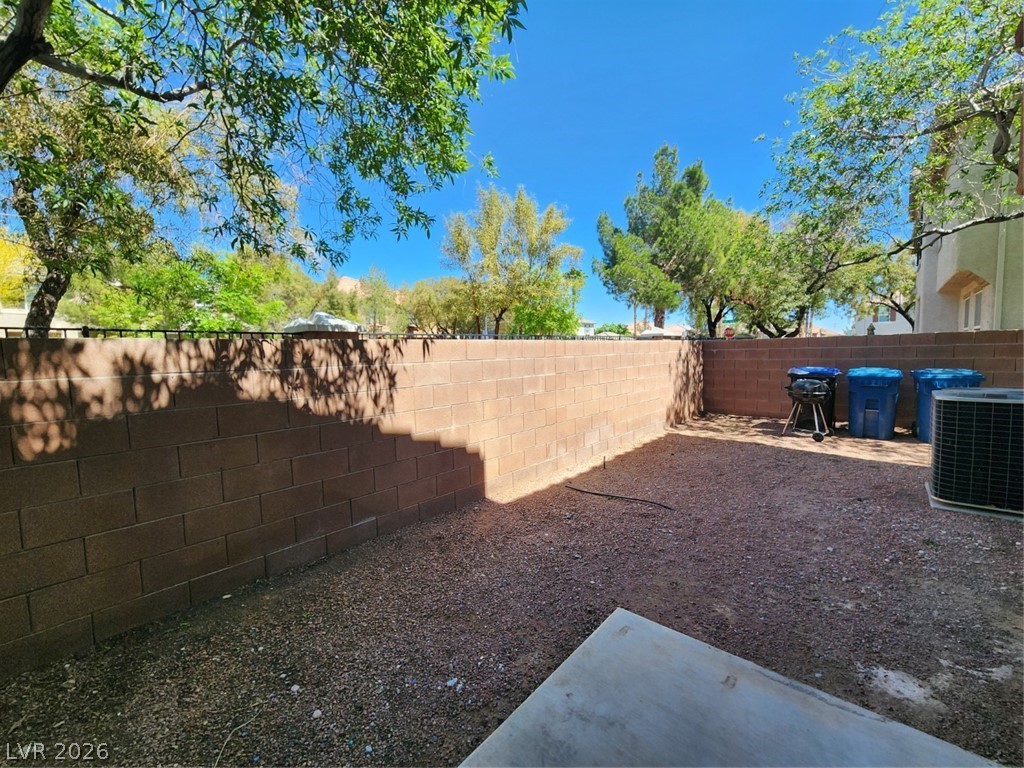 9132 Ripple Ridge Avenue, Unit 102 Las Vegas, NV 89149 - Photo 36 of 42 Fenced backyard with a patio area