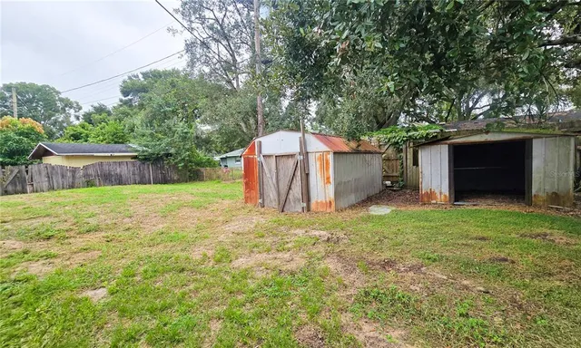 a backyard of a house with table and chairs