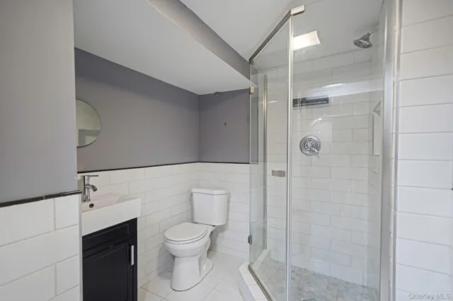 a bathroom with a toilet shower and a sink