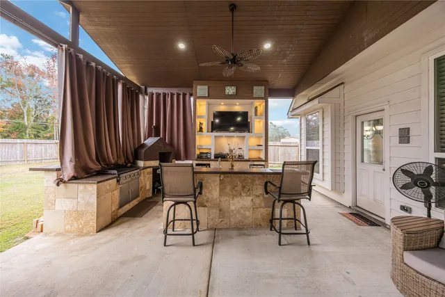 a living room with furniture a ceiling fan and a rug