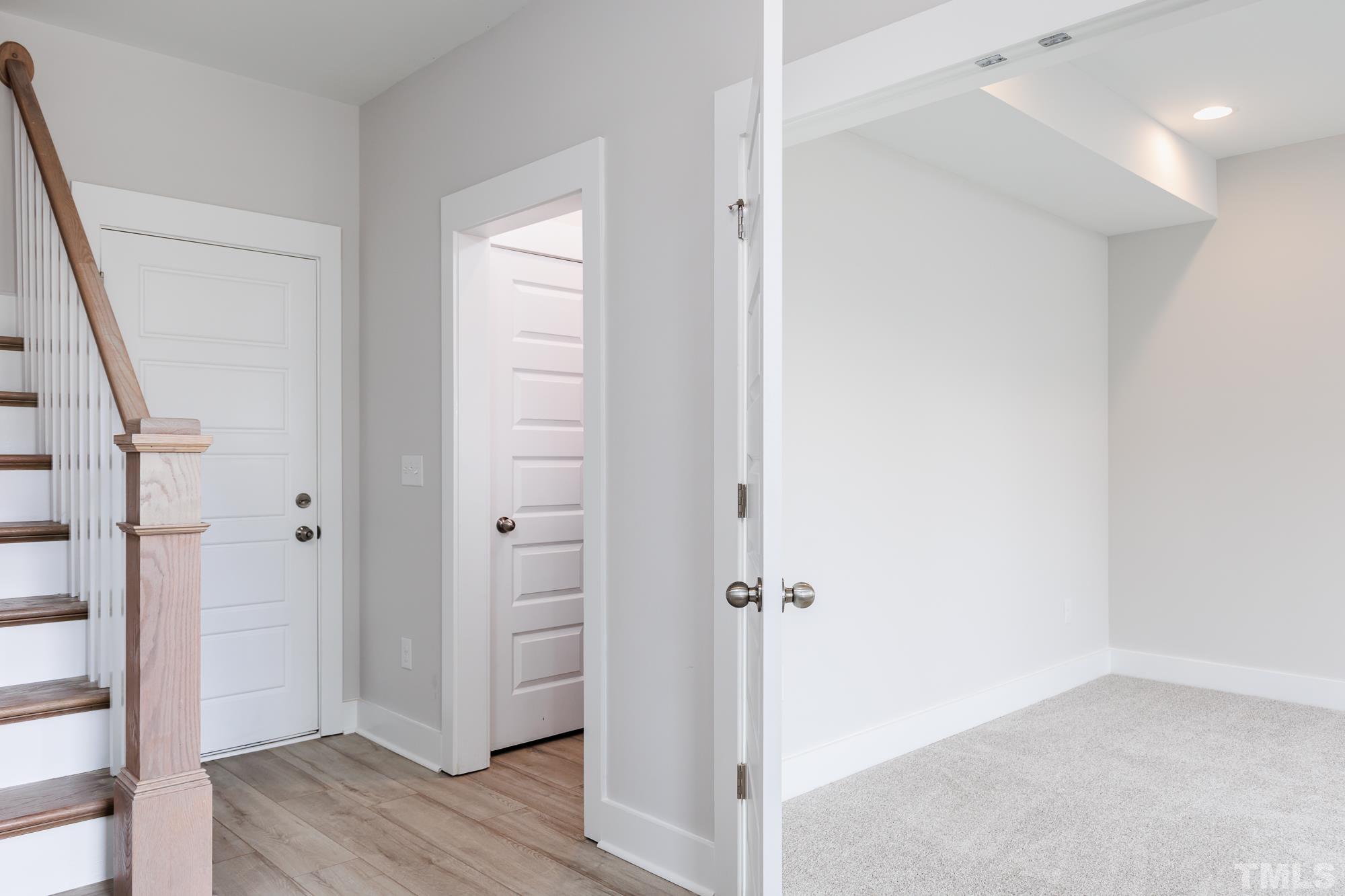 8514 Silsbee Drive Raleigh, NC 27613 - Photo 2 of 18 a view of a hallway with wooden floor and staircase