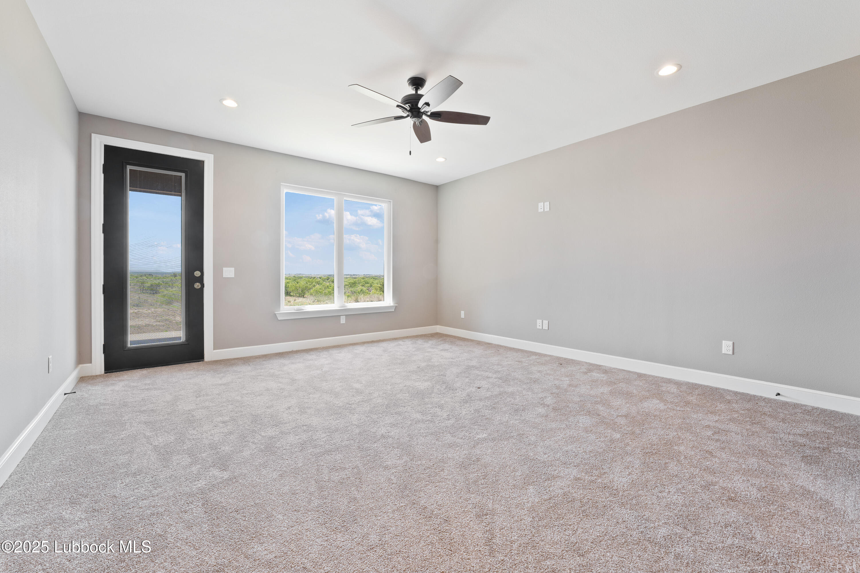 110 Ward Road Snyder, TX 79549 - Photo 19 of 37 an empty room with windows and ceiling fan