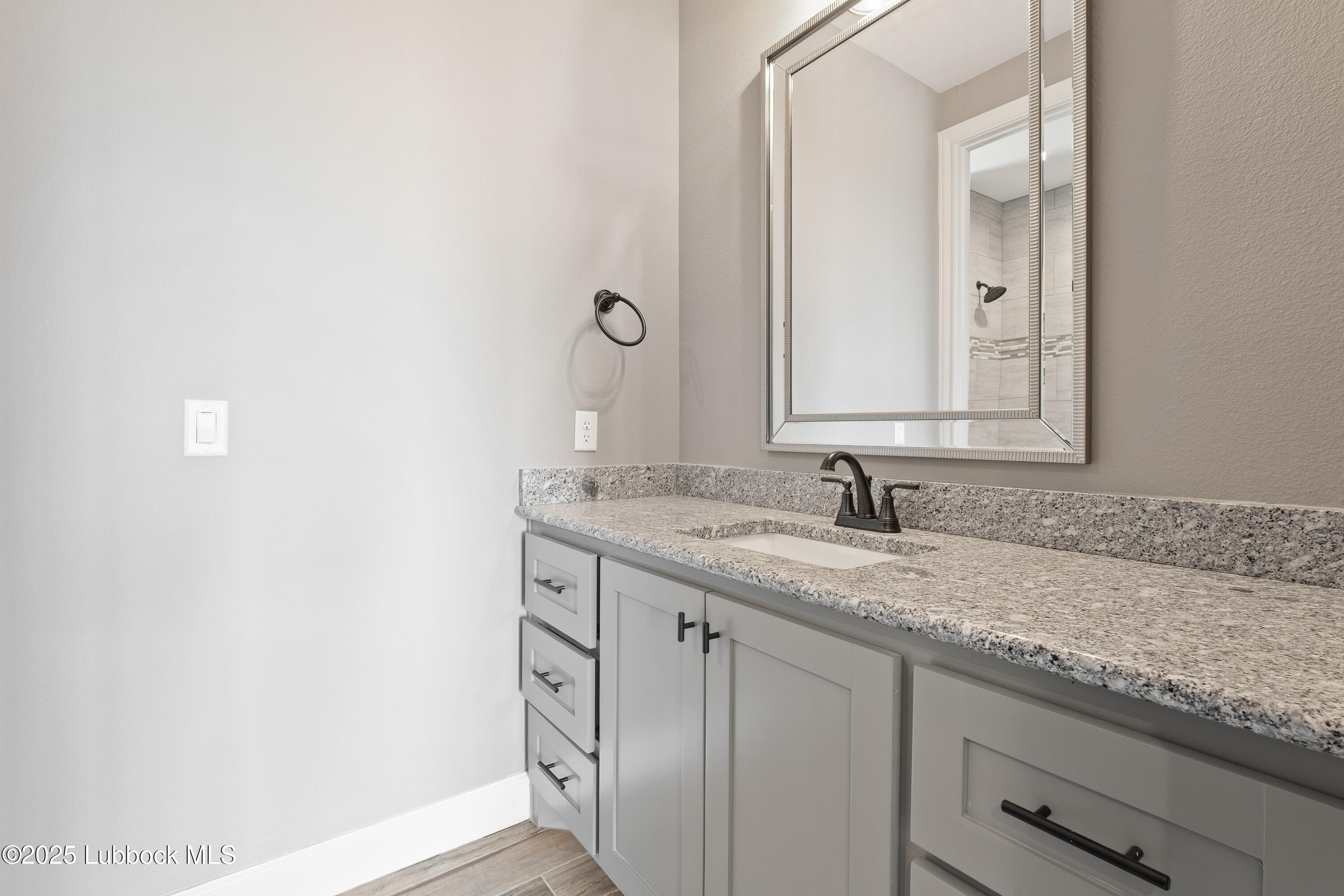 110 Ward Road Snyder, TX 79549 - Photo 21 of 37 a bathroom with a granite countertop sink and a mirror