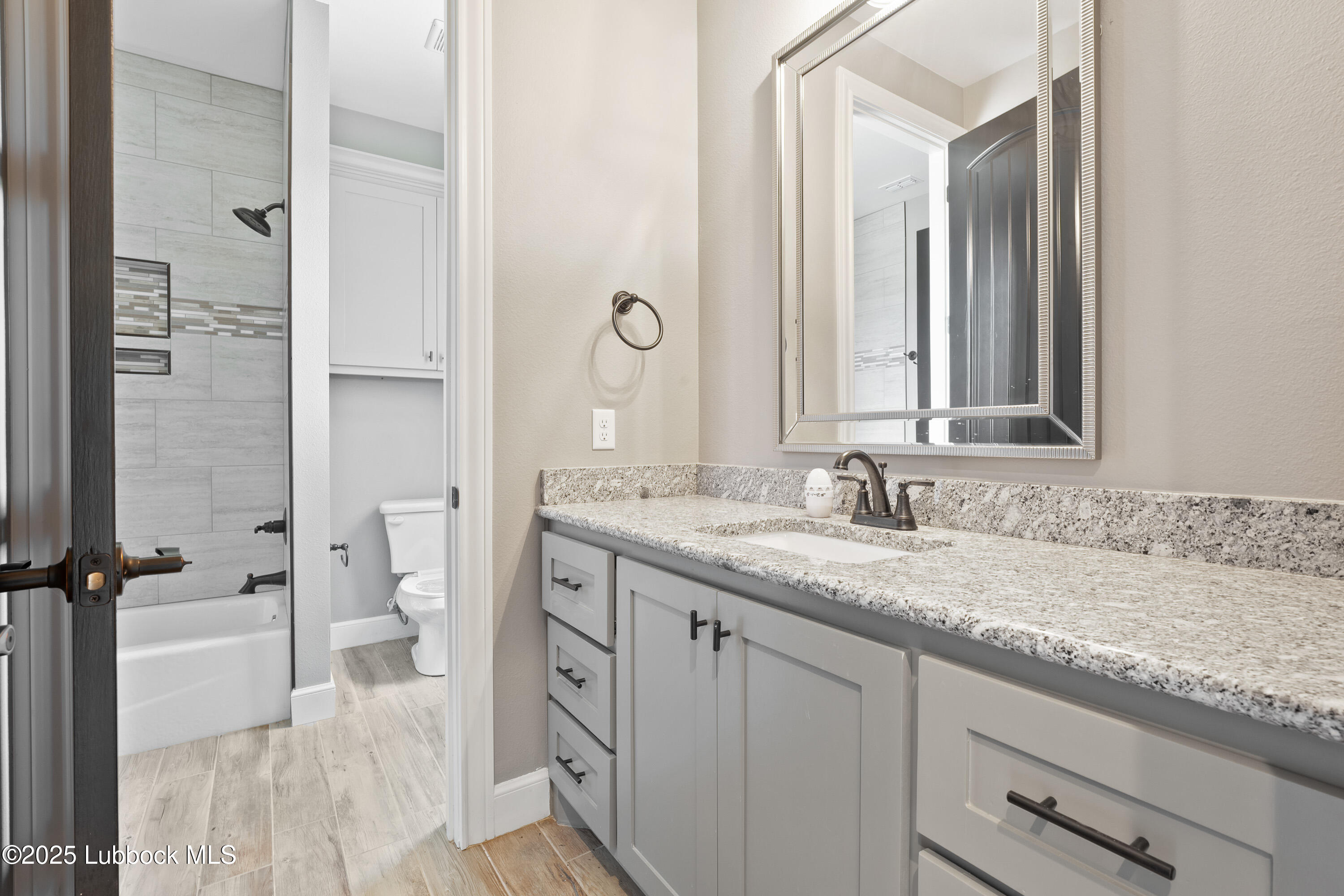 110 Ward Road Snyder, TX 79549 - Photo 23 of 37 a bathroom with a granite countertop sink and a mirror