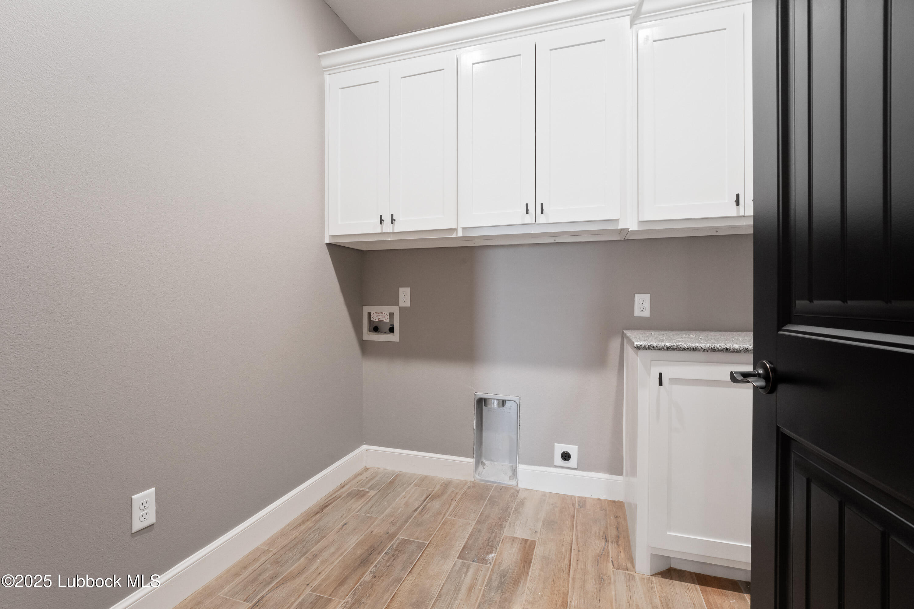 110 Ward Road Snyder, TX 79549 - Photo 27 of 37 a view of a kitchen with white cabinets and a refrigerator