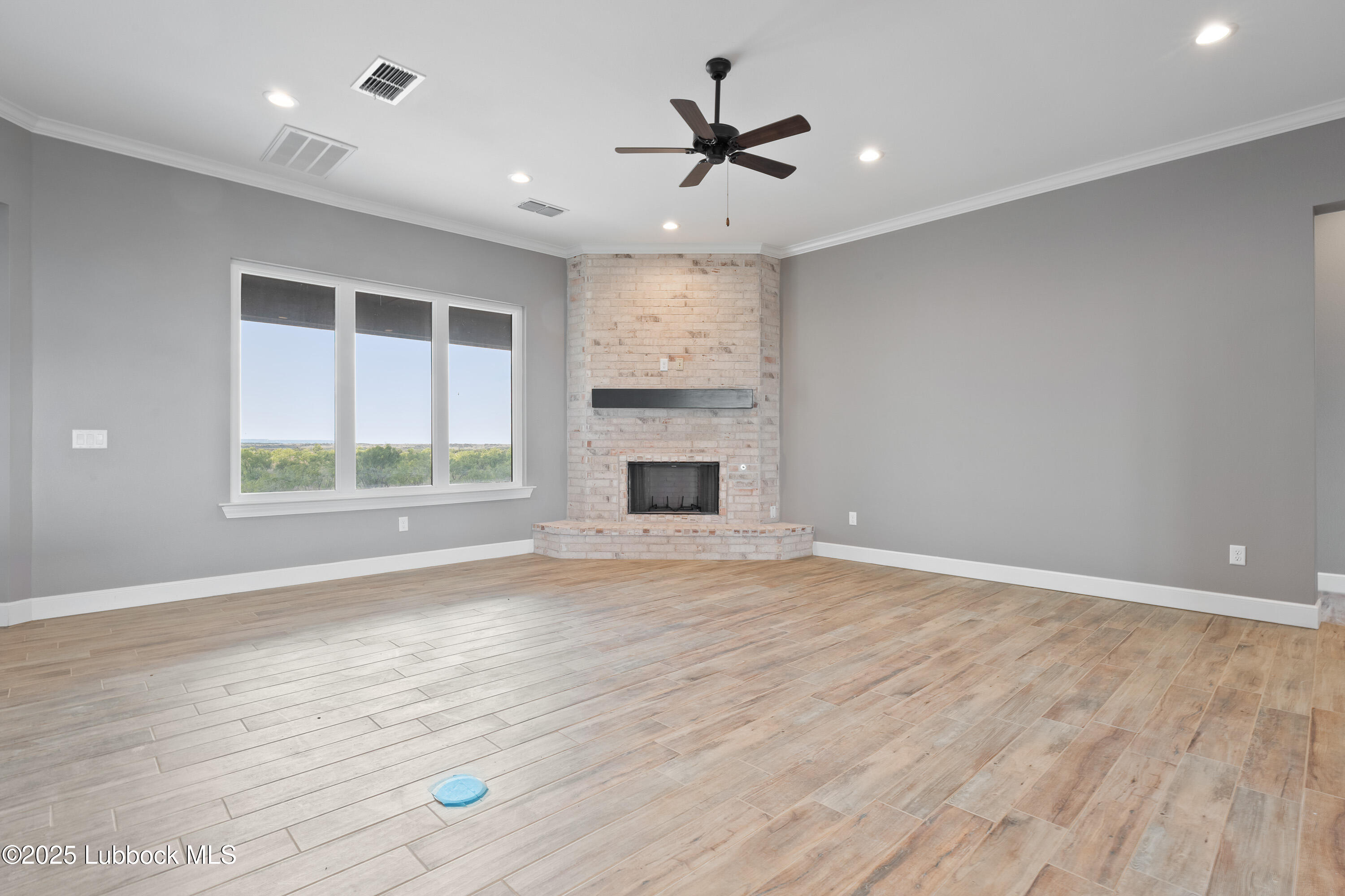110 Ward Road Snyder, TX 79549 - Photo 3 of 37 a view of an empty room with a window and fireplace