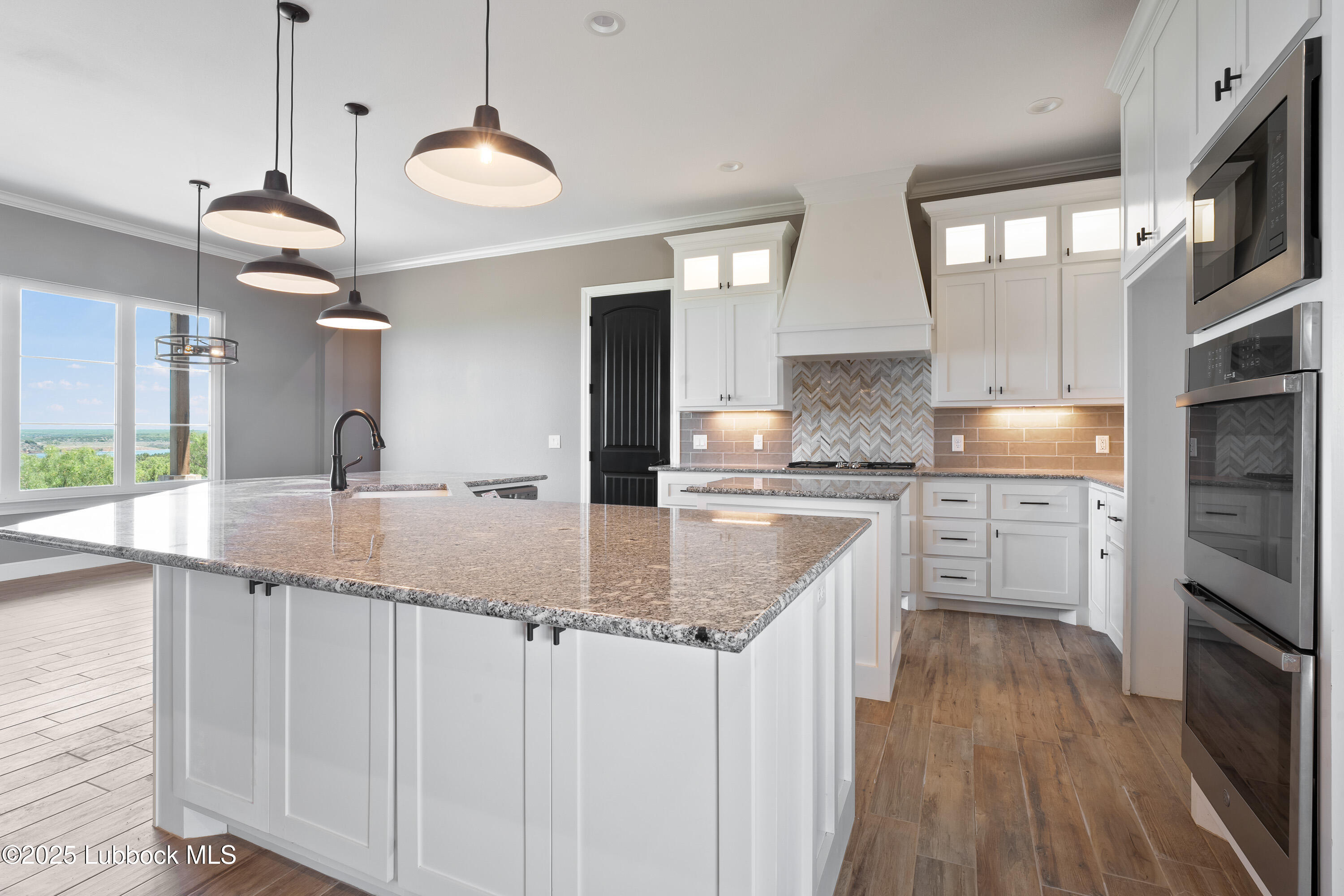 110 Ward Road Snyder, TX 79549 - Photo 7 of 37 a kitchen with granite countertop a sink a counter top space stainless steel appliances and cabinets