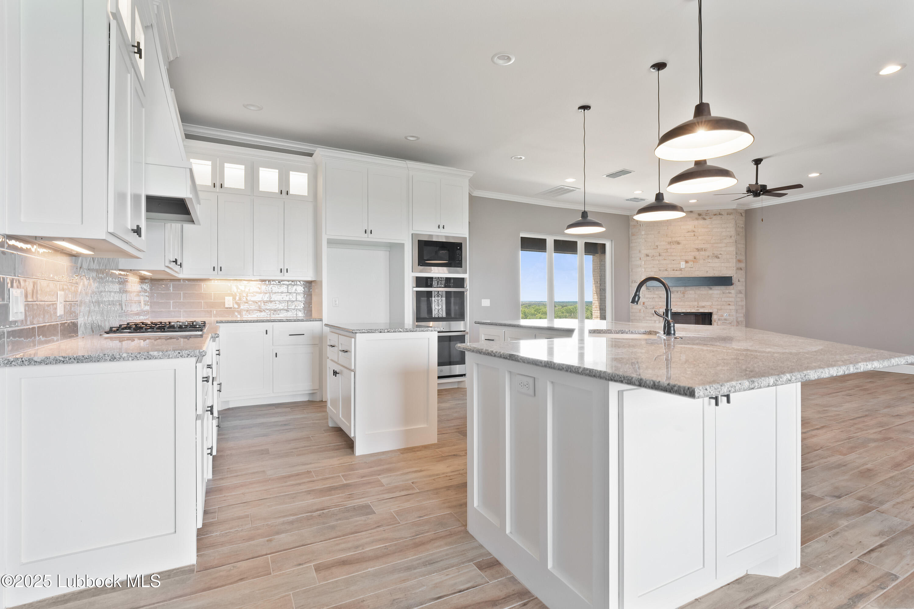 110 Ward Road Snyder, TX 79549 - Photo 8 of 37 a kitchen with kitchen island granite countertop a sink a counter space appliances and cabinets