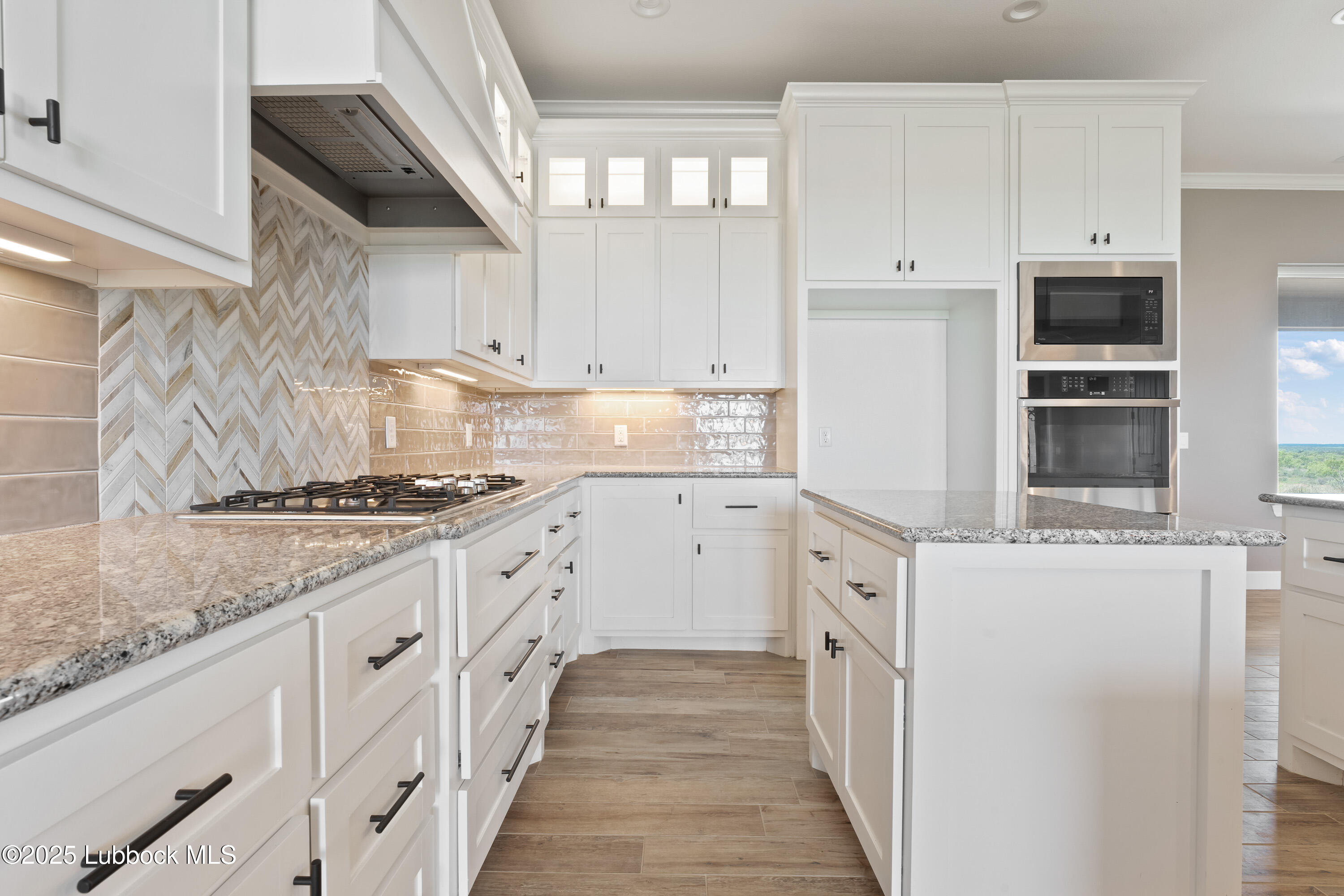 110 Ward Road Snyder, TX 79549 - Photo 9 of 37 a kitchen with granite countertop cabinets stainless steel appliances and a counter space