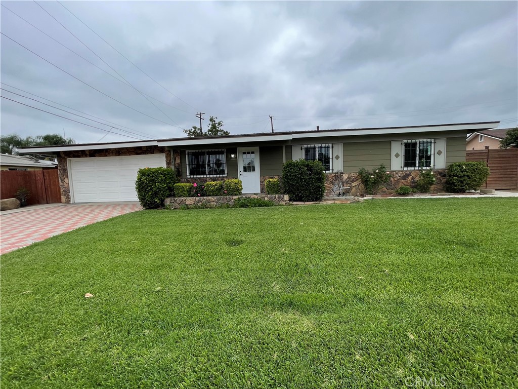 7840 Wells Avenue Riverside, CA 92503 - Photo 1 of 1 a view of a house with a yard and sitting area
