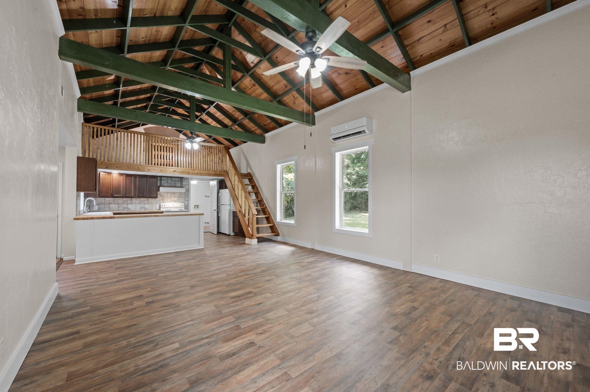 20037 County Road 33 Fairhope, AL 36532 - Photo 47 of 79 Unfurnished living room featuring wooden ceiling, beamed ceiling, a wall unit AC, high vaulted ceiling, and dark hardwood / wood-style floors