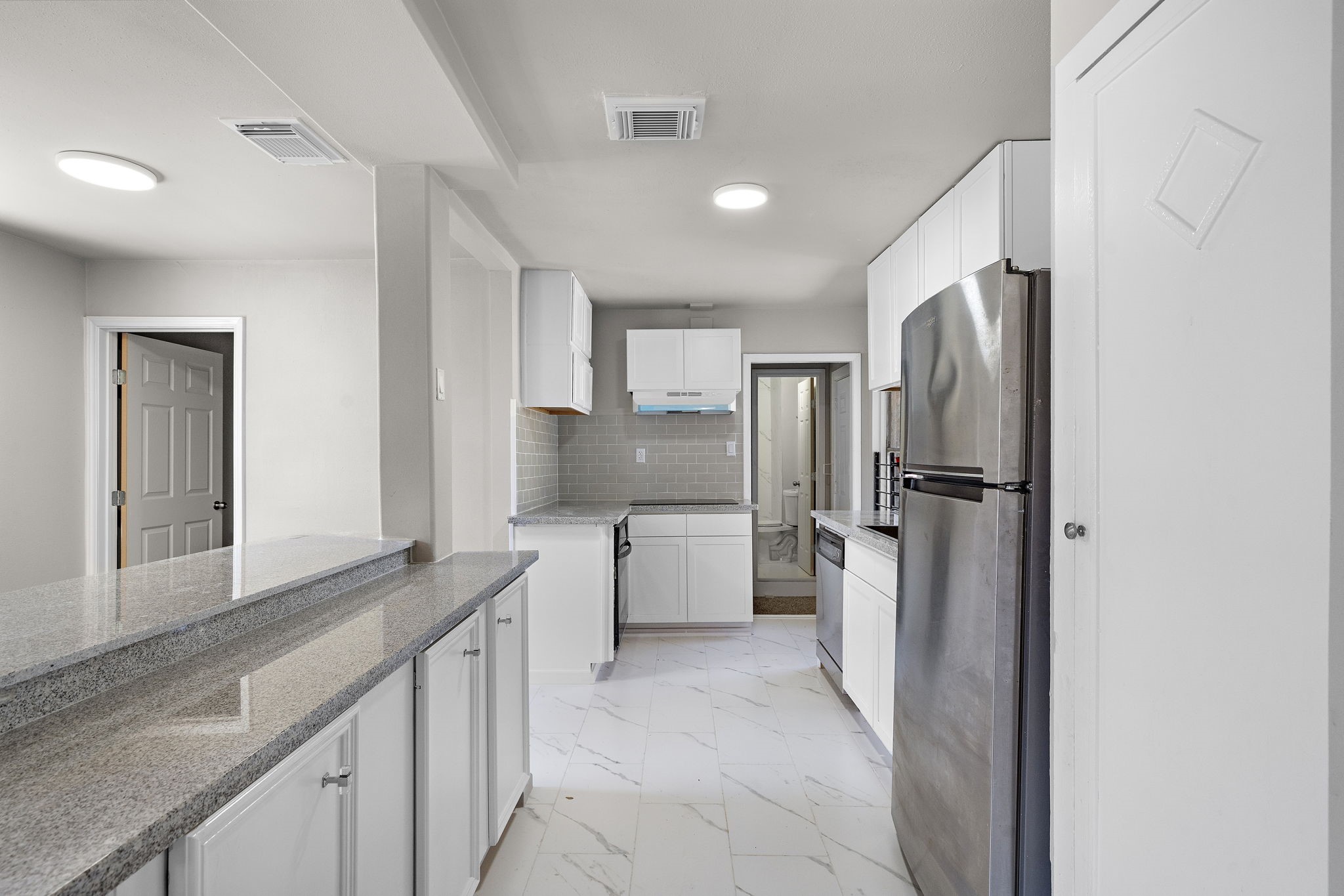 3121 Chimira Lane Houston, TX 77051 - Photo 14 of 35 a kitchen with a refrigerator sink and cabinets