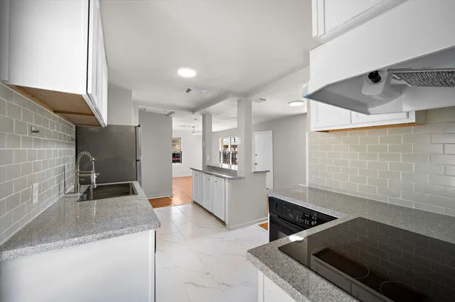 a kitchen with stainless steel appliances granite countertop a sink and a stove