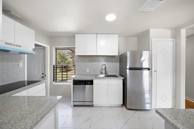 a kitchen with a refrigerator sink and stove